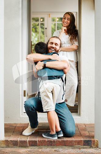 Image of Loving dad hug and embrace son, love from father to son or parents saying goodbye to child on front porch at home. Happy family greeting little boy with mother standing in doorway or house entrance.