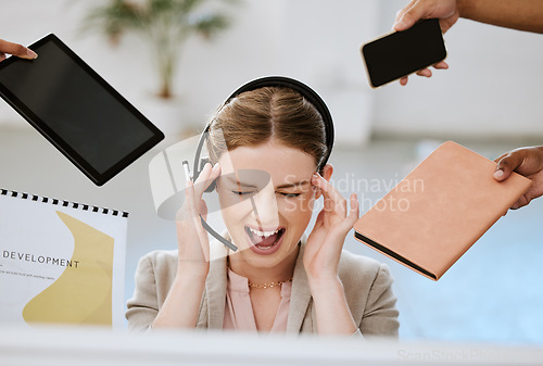 Image of Stress, burnout and overloaded woman at work in a modern office. Female contact centre agent overwhelmed with all the work from her call center colleagues with anxiety and headache in the workplace.