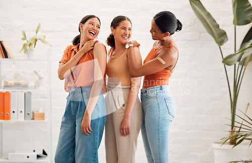 Image of Female friends after receiving covid vaccine, happy and smiling, approving the immunity injection showing bandage plaster arms. Diverse women recommend booster jab for protection from corona virus.