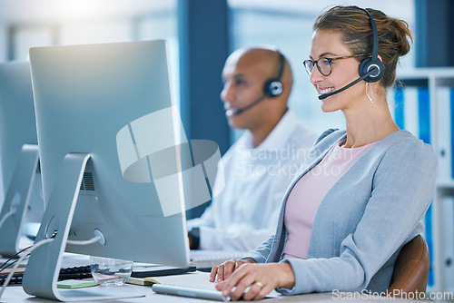 Image of Call center agent, telemarketing sales and customer service operator smiling while working on a computer and talking to a customer. Sales representative happy to help and answer calls for support