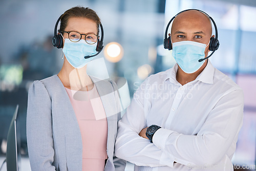 Image of Customer service workers, with protection from covid and wearing masks for heath. Online support, IT or call center employees with headset, social distancing during corona virus pandemic or lockdown