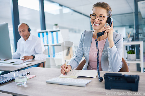 Image of Smiling receptionist, business woman or customer service employee consulting on phone in telemarketing call center office. Happy corporate or crm support manager working in contact us helpdesk