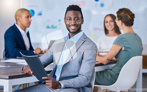 Image of Portrait of a confident business man leading a meeting in a modern office, smiling and empowered. Happy black male discussing innovative strategies, marketing, planning and creative startup strategy