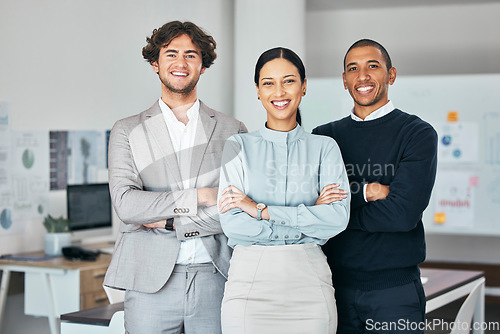 Image of Teamwork, unity and togetherness with a corporate team portrait of colleagues standing arms crossed in their office at work. Young, motivated and ambitious business people with a mindset of growth