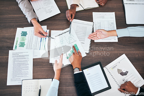 Image of Business teamwork hands in a sales, marketing and forecasting projection meeting or group discussion about company strategy for growth development. Top view of people looking at chart, graph and data