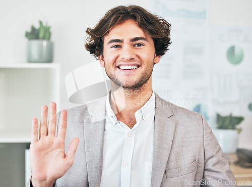 Image of Waving, greeting and friendly business man with a bright smile attending a virtual meeting or video call. Portrait of a cheerful, joyful and excited male employee joining an online webinar