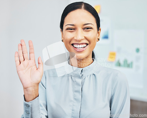 Image of Woman waving hand to greet hello while introducing, smiling and gesturing during video call via webcam in virtual meeting in an office. Portrait of a young, friendly and happy female business intern