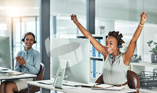 Image of Call centre, cheerful and agent celebrating with arms up at her office desk. Successful, professional and positive customer review or bonus. Helpdesk worker excited with salary performance increase.