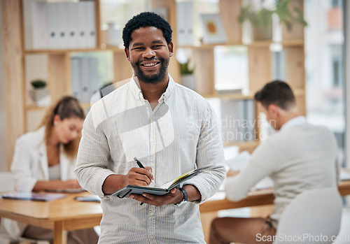 Image of Business man planning ideas in book, writing notes and planning his routine schedule while working in an office. Portrait of a corporate professional worker, employee and manager at startup company