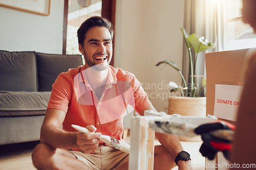 Image of Real estate, decor and fun couple bonding while painting and moving into their new house together. Smiling husband and wife laughing while doing interior decorating and completing a diy home project