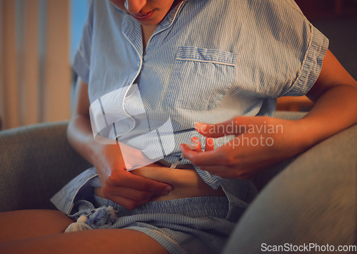 Image of Diabetes, insulin and medication with a diabetic woman injecting herself with a shot of medicine to balance her blood sugar. Closeup of a female self medicating with a needle and syringe at home