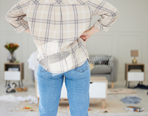 Image of Spring cleaning, messy, dirty room with woman feeling annoyed, frustrated and tired. Tidying and arranging untidy living room, lounge and home space for personal hygiene or after a break in or theft