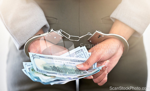 Image of . Handcuffs, dollars and a business woman arrested for theft at work. Money, crime and punishment for fraud with female lawyer in prison. Cash, restraints and a criminal trying to bribe an officer.