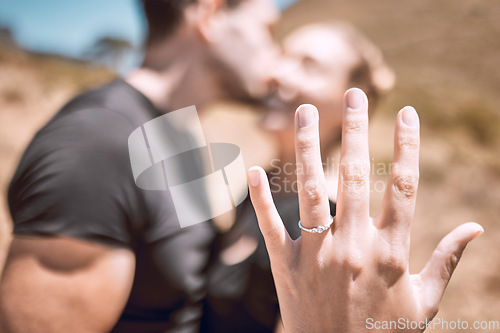 Image of Engagement, proposal and romance while showing off her diamond ring and saying yes to marriage outside. Closeup hand of a young romantic couple telling you to save the date for their wedding day