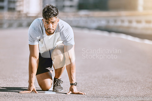 Image of Runner in starting position for race, run or cardio for healthy exercise, workout or fitness in urban city. Active, fit and serious male sports athlete ready for training, running fast and sprint