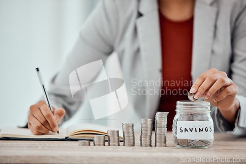 Image of Finance, budget and saving money or coins by depositing currency, cash or pennies in glass jar. Financial advisor hands, manager or accountant writing in book, planning or investing in company future