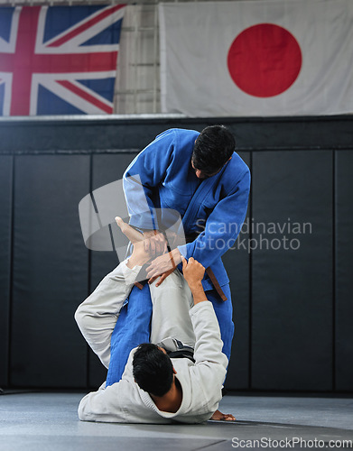 Image of Martial arts, karate or judo fighters and athletes fighting in a competition, match or tournament. Japan vs UK, self defense and protection professionals with skill fight in a dojo to win and compete