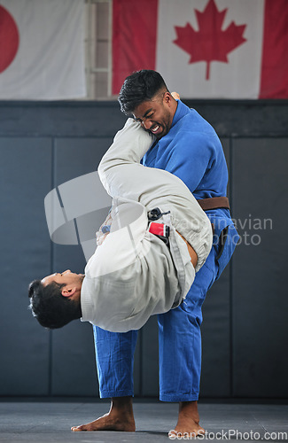 Image of . Mma, training and fighting with a student and teacher exercising during a self defense workout in a gym or fight studio. Combat sport with a fighter and his opponent in gi or uniform in a match.