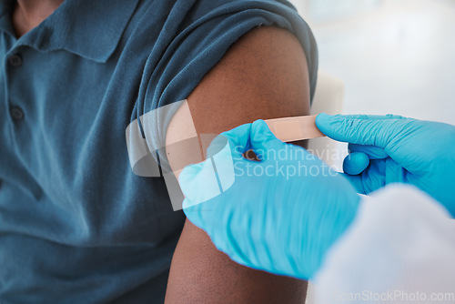 Image of Corona, compliance and the vaccine being given to man by a health care worker. Closeup of a nurse putting a plaster on a man after an injection or treatment. Male making decision to get booster shot