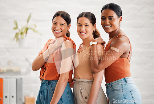 Image of Band aid, vaccine and injection for covid, flu or pandemic virus to protect from disease, sickness or illness. Portrait of diverse creative business women group showing, endorsing or supporting cure