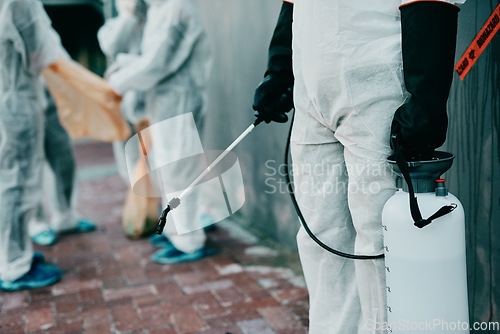 Image of Healthcare workers, cleaning and working to prevent an outbreak of covid. Medical worker in sterile uniform, holding disinfectant and sterilizing. People in protective suits disinfecting the area.