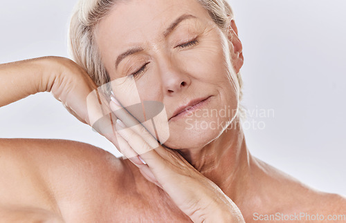 Image of Skincare, beauty and wellness with health, skin and face of a senior woman in a studio on a purple background. Relax, spa and skin care with an elderly, calm model feeling healthy, happy and natural