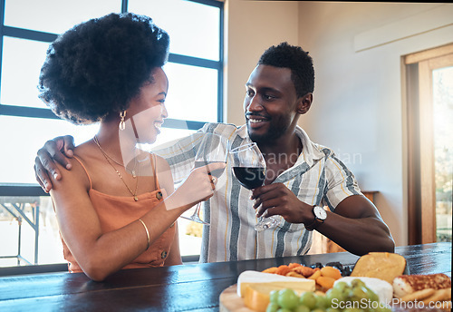 Image of Celebration, love and black couple toasting with wine on a romantic date indoors, bonding and flirting. Lovers happy, in love and carefree, celebrating their anniversary and sharing intimate moment