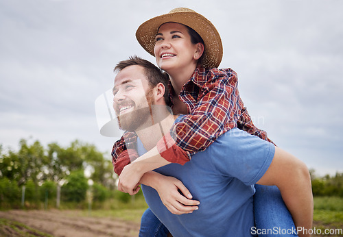 Image of Playful, agriculture farmer couple having fun on a farm, countryside or nature environment enjoying rustic, sustainable living lifestyle. Happy, caring and in love husband giving wife piggyback ride