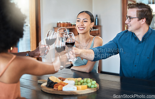 Image of Friends, fun and celebration with diverse group toasting with red wine to good news, bonding at a restaurant. Young friends reunion, happy to be together and enjoy wine tasting with charcuterie board