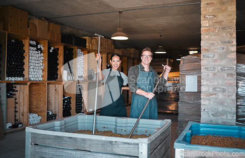 Image of Wine making, production and cellar workers crush, blend and stir open tank for alcohol process. Portrait of happy staff in factory and winery industry for distillery and manufacturing warehouse