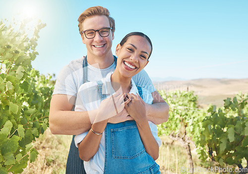 Image of In love, countryside and farmer couple enjoying grape vine plant growth development in summer with flare or sunlight and blue sky. Happy, young rustic people hugging on a sustainable farm or vineyard