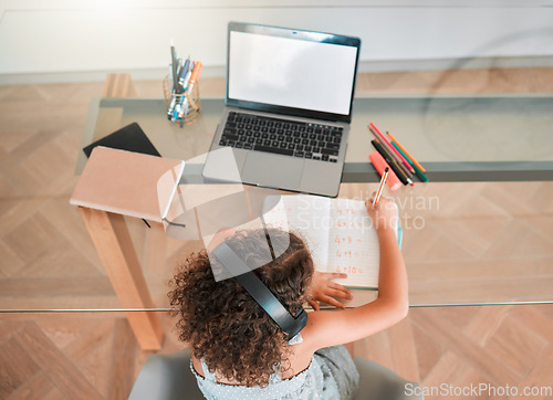 Image of Education, distance learning child listening headphones and internet on laptop for online activity or a web teaching lesson at home. Smart student busy writing maths homework or test in a notebook