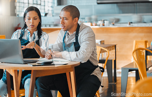 Image of Cafe store owners planning budget, brainstorming coffee shop innovation strategy on laptop, taking notes. Startup entrepreneurs small business meeting, discuss restaurant financial goal and vision.