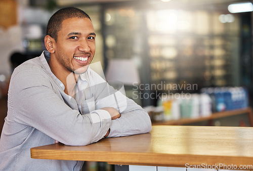 Image of Entrepreneur or small business owner of cafe or coffee shop at counter happy and smiling. Young, confident and successful boss, manager or leader of a hospitality startup restaurant, bistro or store