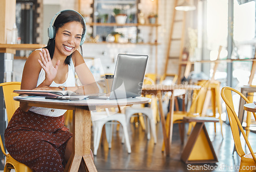 Image of Webinar meeting at internet cafe with woman on laptop video call with headphones waving, greeting webcam in coffee shop. Business freelance worker with smile in zoom meeting for remote global company