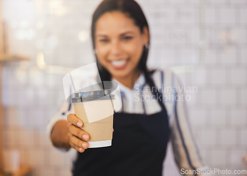 Image of Coffee shop, closeup and barista holding cup and giving it to the customer at cafe. Female restaurant service worker in beverage business. Small business, management and food worker serving client.