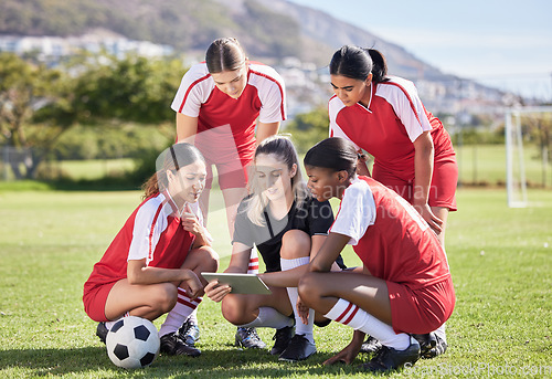 Image of Soccer, sports and woman athlete players planning, discussing and briefing game plan by coach on digital tablet. Teamwork, training and speaking female footballers at stadium field with goal posts