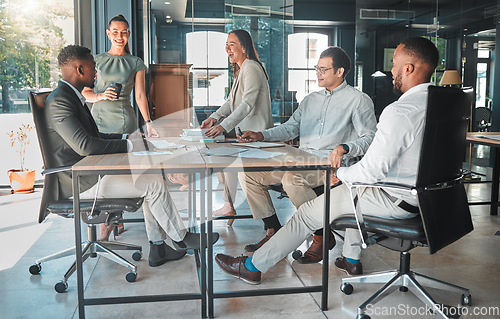 Image of Business meeting in a boardroom of colleagues talking and planning company growth strategy together. Group or team of diverse and happy employees having a discussion in a modern office