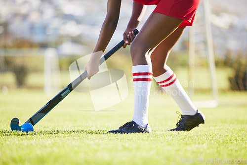 Image of Hockey practice or game workout or sports training with a player exercise fitness for a match or sport field event. Strong athlete being active, healthy and fit running outside with ball with a stick