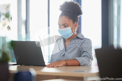 Image of Covid, face mask and a black woman working on a laptop in a modern office. Sick businesswoman on the internet at work. College student, online exam and in campus library, protected against the virus.