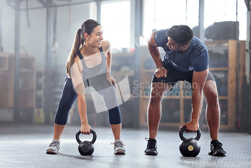 Image of Strong, wellness couple doing kettlebell weight exercise, workout or training inside a gym. Happy sports people or trainer motivation, exercising with fitness equipment for muscle, strength or health