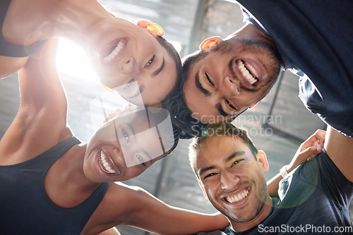 Image of Fitness, workout and exercise group huddle and hug with an excited energy, motivation and teamwork. Team of training friends looking happy with community support at a sports wellness gym or club