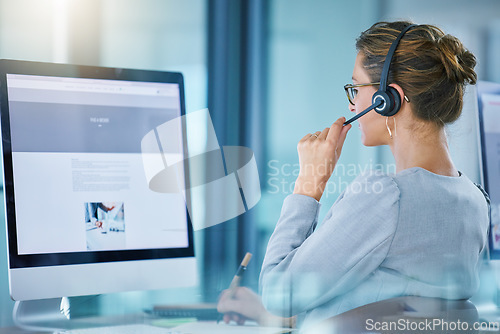 Image of CRM call center agent talking using wireless headset, consulting client online, giving feedback, working on computer. Helpdesk hotline support operator browsing internet doing customer service work.
