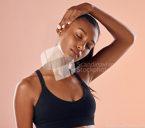 Image of Fitness, wellness and sports woman stretching sore neck, pain and injury after studio workout, exercise or training. Motivation, active and athletic health model getting ready against pink background