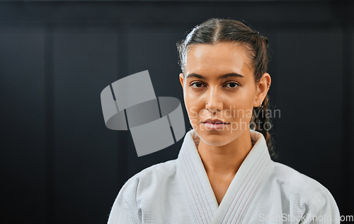 Image of Karate, martial arts or taekwondo woman, coach or trainer with vision, motivation or power in wellness gym. Fitness portrait of serious or fit sport fighter after health workout, exercise or training