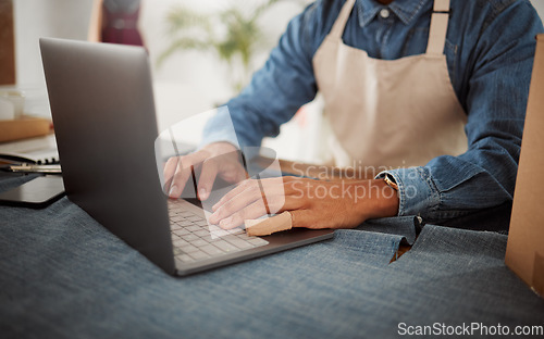 Image of Online order, fashion designer or tailor typing invoice, browsing and searching internet for clothing inspiration. Closeup hands of man in workshop, studio and boutique for trendy and stylish clothes