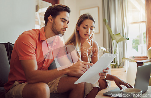 Image of Anxiety, debt and stress with a couple paying bills on a laptop, checking their budget and savings. Young husband and wife looking worried while reading a loan application or contract together