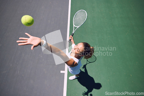 Image of Fit tennis player, sport and serving during training, workout and exercise or match, game and competition from above. Sporty, active and healthy woman throwing a ball and practicing serve with racket