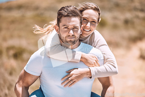 Image of Playful and playing piggyback couple smiling, bonding and enjoying outdoors in summer or spring. In love, dating and in relationship partners playing and having fun on a romantic date together.