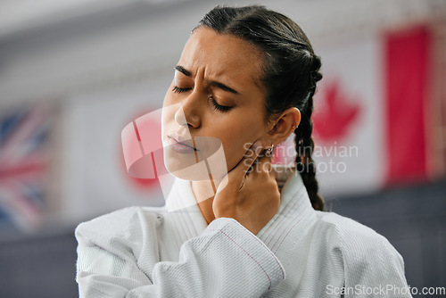 Image of Woman karate student with bad neck pain at fitness training studio, person holding head from sport injury at health gym and muscle cramp from learning self defense at school. Painful joint accident